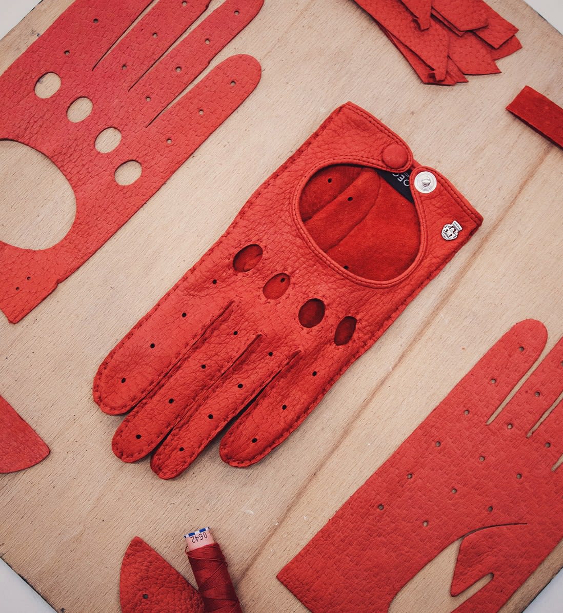Cut-out of a red Roeckl driving leather glove