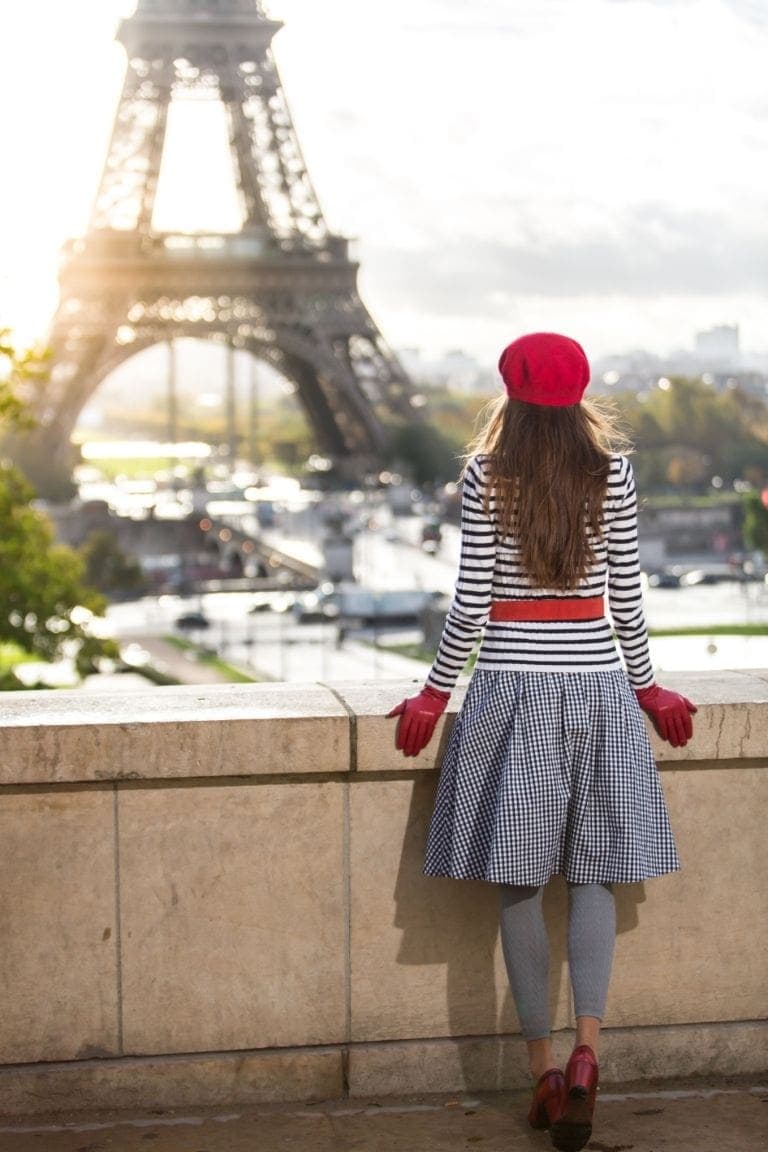 Woman with red gloves in front of Eiffel Tower in Paris