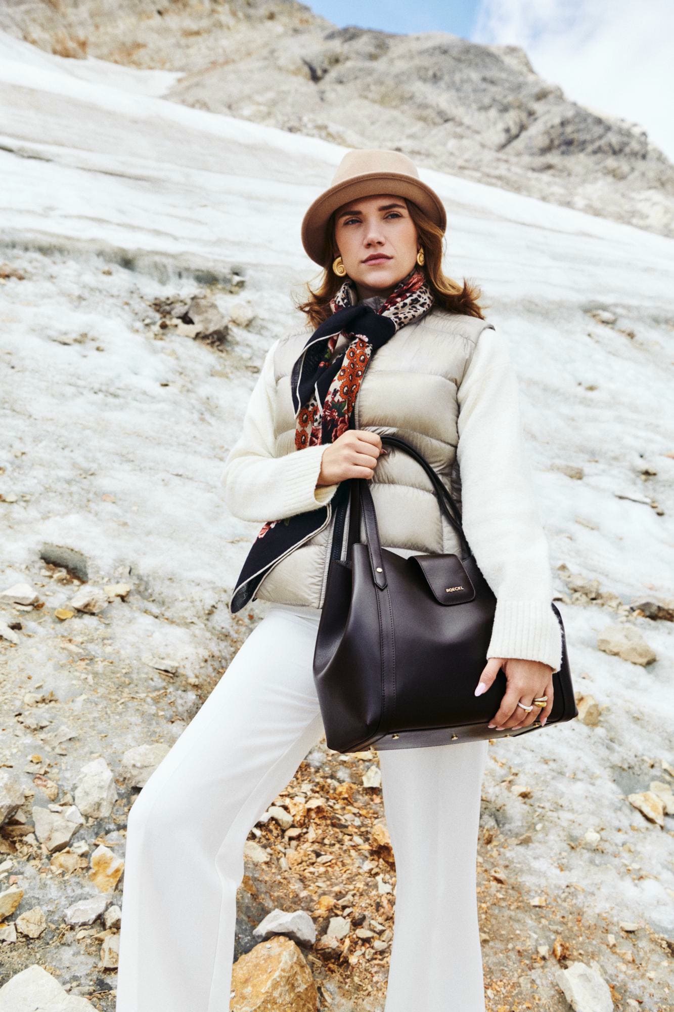 The Roeckl Women\'s Handbag Soho Crossover in burgundy and beige with modern Roeckl logo are buttery soft and are perfect companions for autumn and winter.