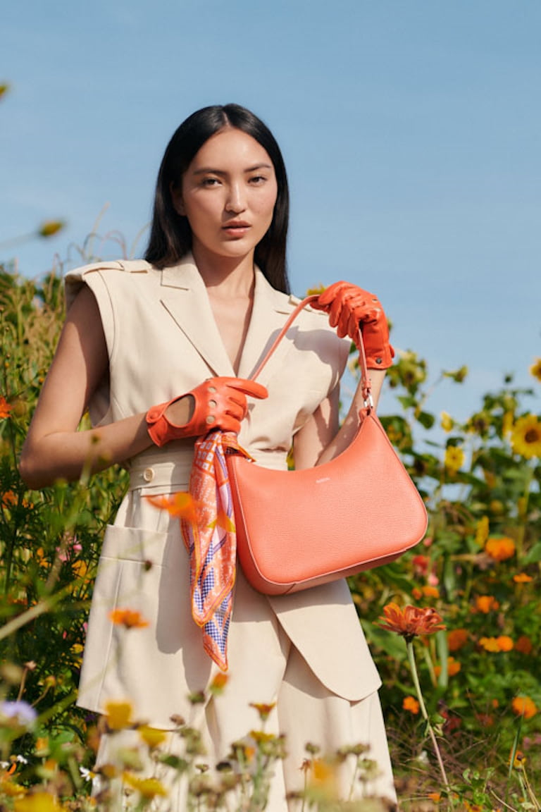 The Cleo bag in orange-red is the perfect bag for the summer.