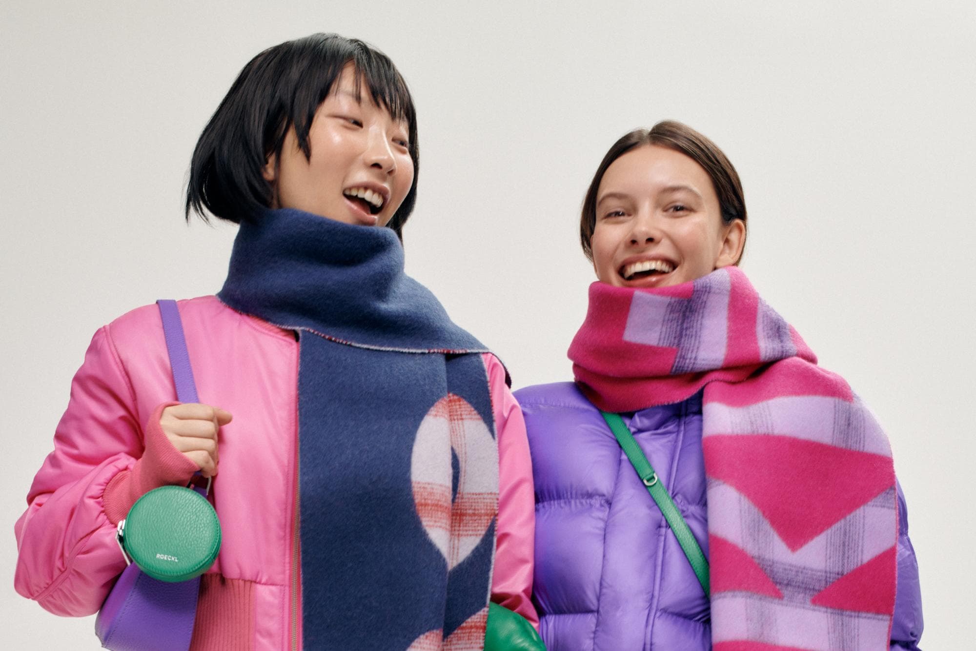 Der Schal Logo Check in blau oder pink bringt farbige Freude in den Winter.
